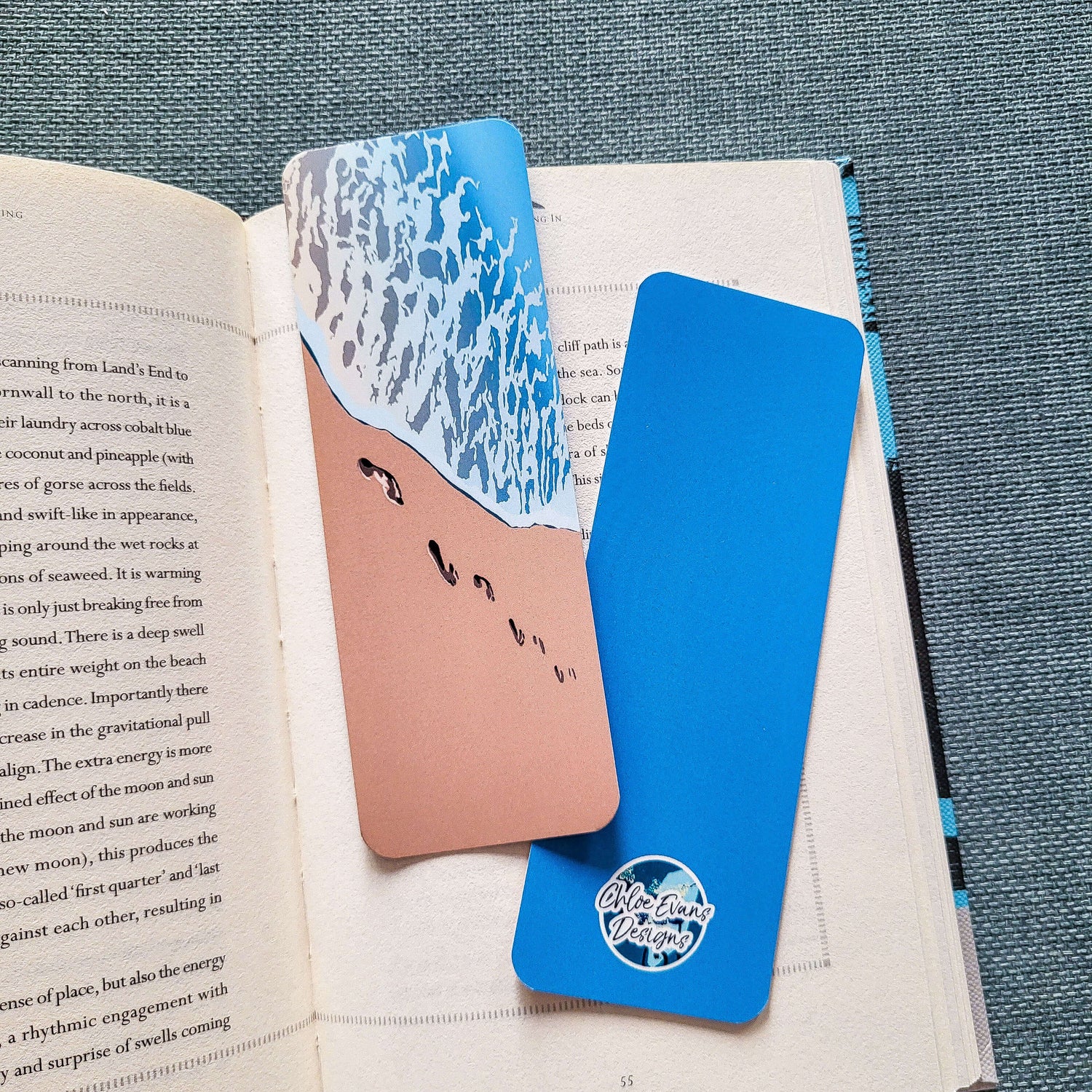 Illustrated bookmark showing footprints in the sand along the shoreline – design titled “Leave Nothing But Footprints” by Chloe Evans Designs