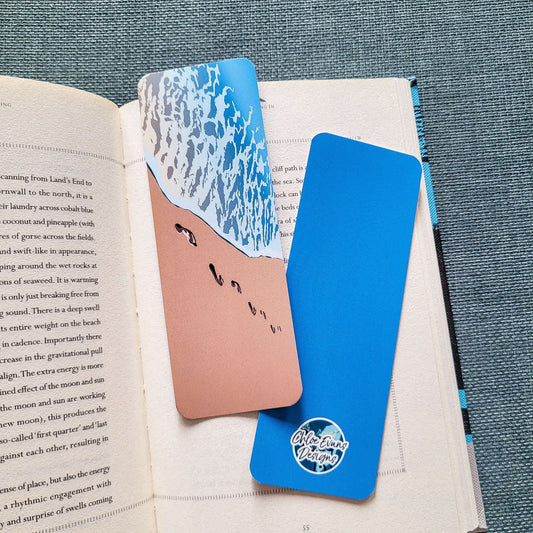 Illustrated bookmark showing footprints in the sand along the shoreline – design titled “Leave Nothing But Footprints” by Chloe Evans Designs