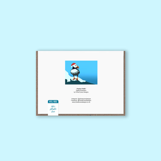 The back of a Christmas greeting card showing the design thumbnail of a puffin in a Santa hat with business details for Chloe Evans Designs
