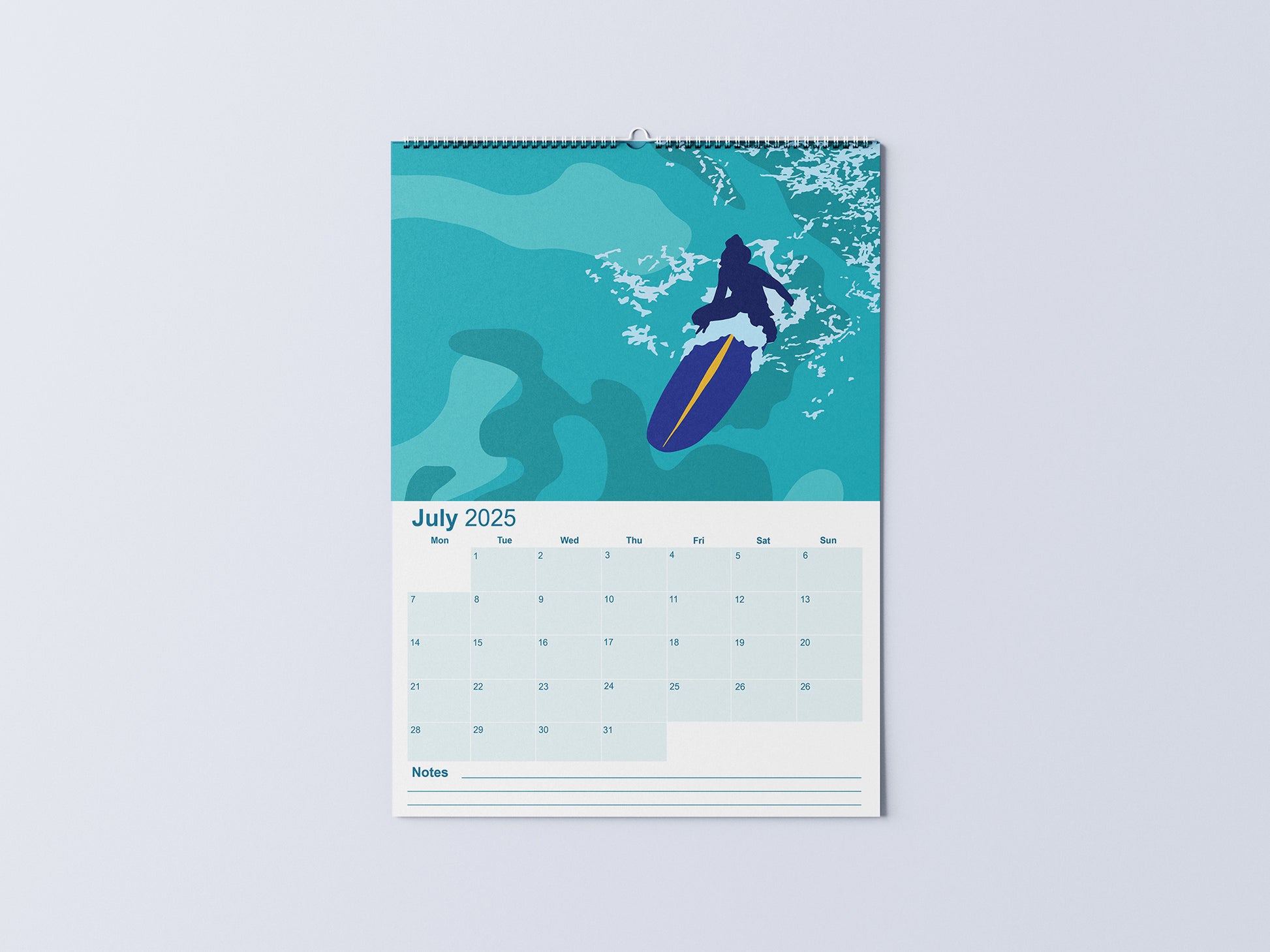 Digital mockup of an A3 coastal wall calendar, showing the July page with an illustration of a surfer sat on her board in the ocean.