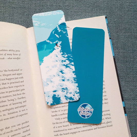 Bookmark featuring a surfer riding a wave with white water splashing around – surf design by Chloe Evans