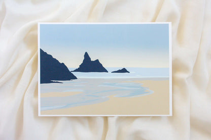 Photo of blue and beige Broad Haven South beach wall print on cream fabric backdrop.