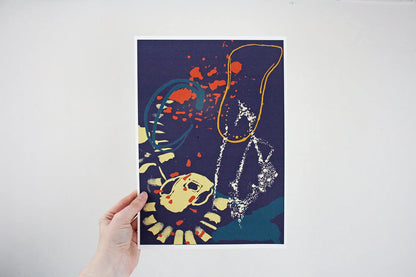 Photo of hand holding navy, yellow and orange Coastal Journey 1 abstract A4 print