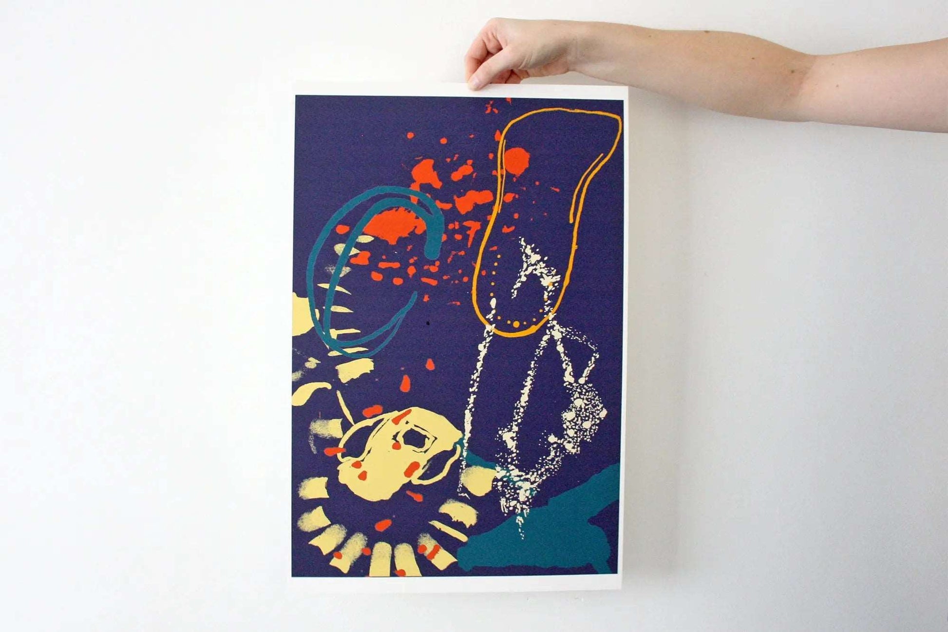 Photo of hand holding navy, yellow and orange Coastal Journey 1 abstract A3+ print