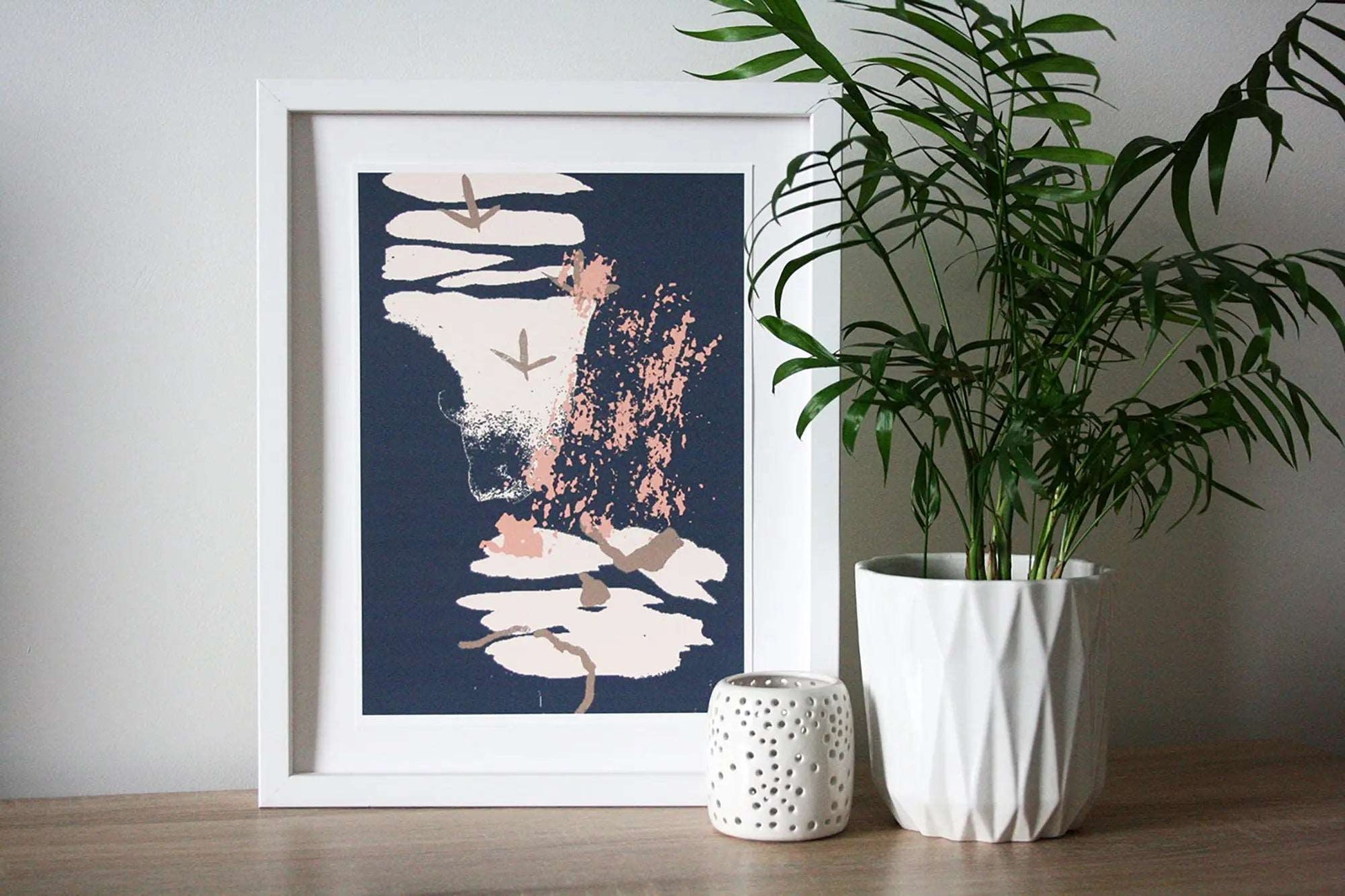 Photo of blue/grey, brown and pink Coastal Journey 12 abstract A4 print in white frame with white tealight holder and house plant