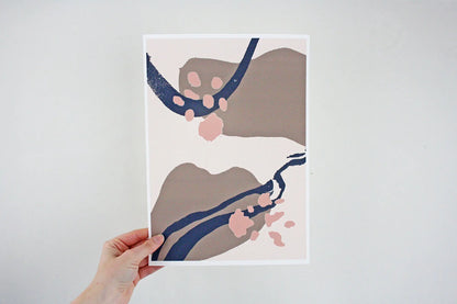 Photo of hand holding dusky pink, brown and blue Coastal Journey 16 abstract A4 print