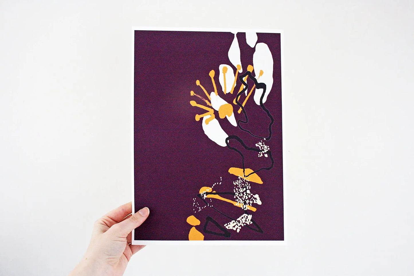 Photo of hand holding purple and yellow Coastal Journey 6 abstract A4 print