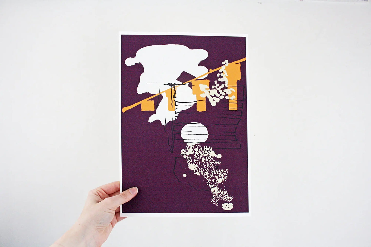 Photo of hand holding purple and yellow Coastal Journey 7 abstract A4 print