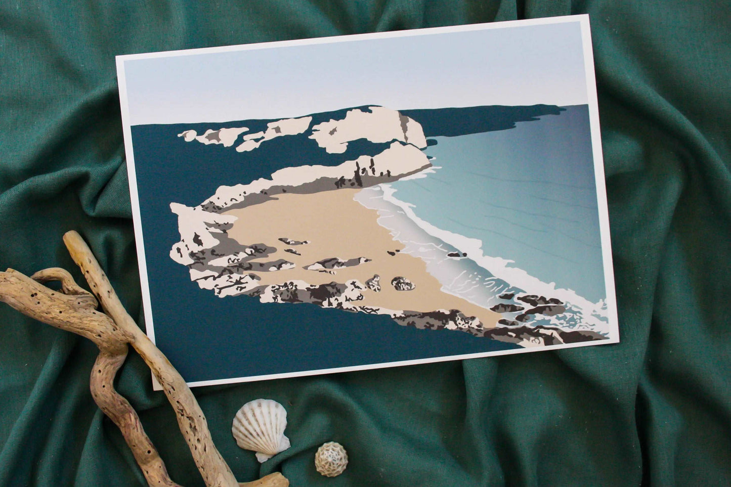 Fall bay wall print on green fabric backdrop with driftwood and shell props