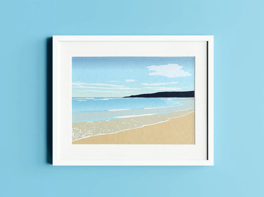 Digital mock up of blue and brown Freshwater West print in white frame on light blue wall background