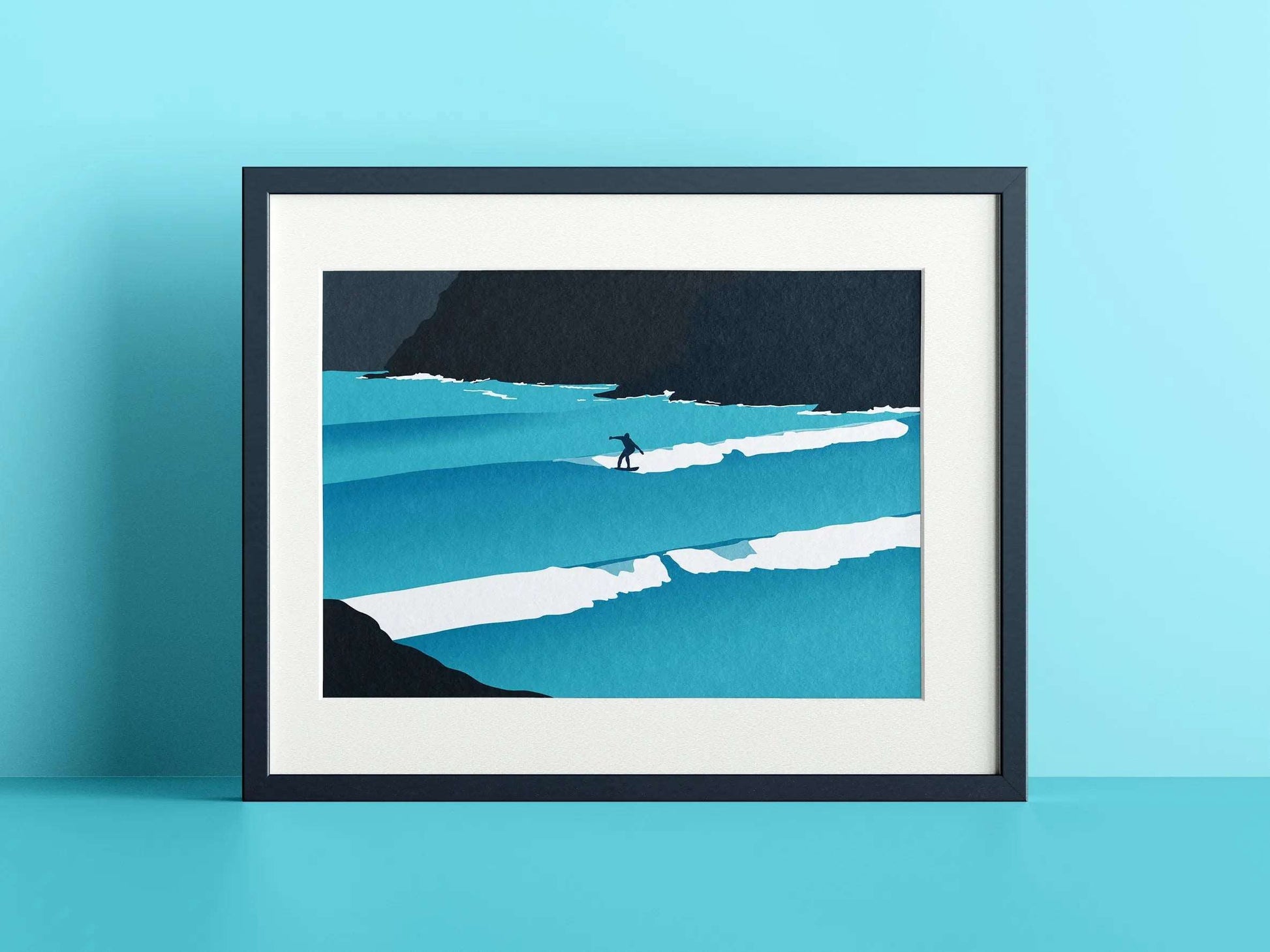 A print of a solo surfer riding a wave, in a navy print on a blue wall