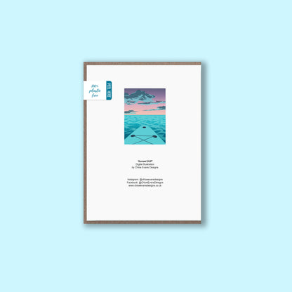 A mockup of the back of a greeting card showing illustration of a purple sunset from the viewpoint of a paddle boarder on their board that is on the front with business details, with a brown envelope behind, on a light blue background.