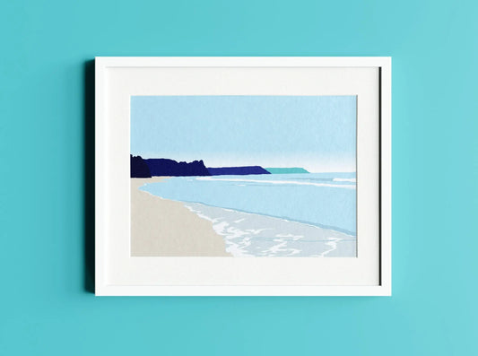 Digital mock up of Oxwich bay illustration print in frame on turquoise blue wall background.