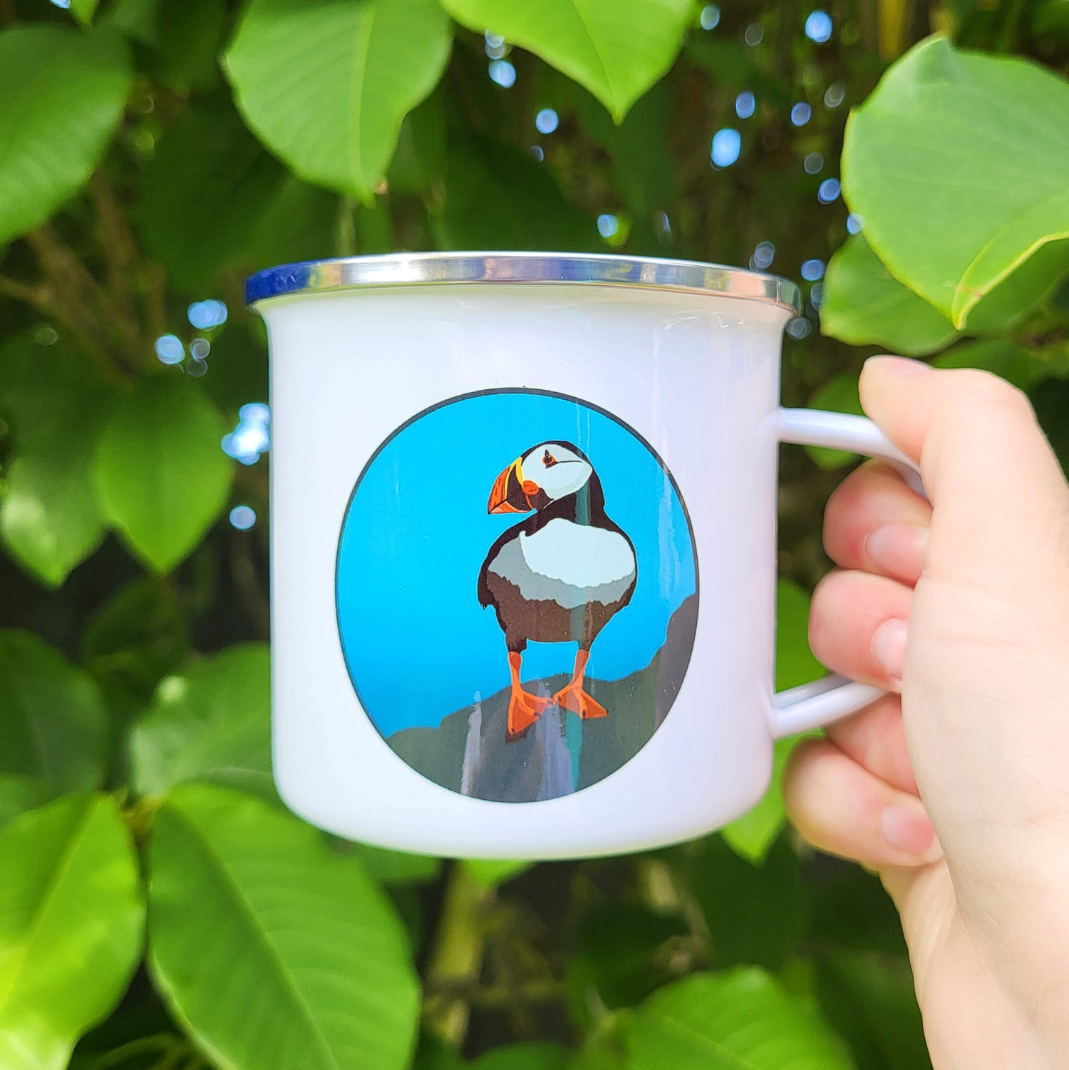 Puffin enamel camping mug with playful seabird design