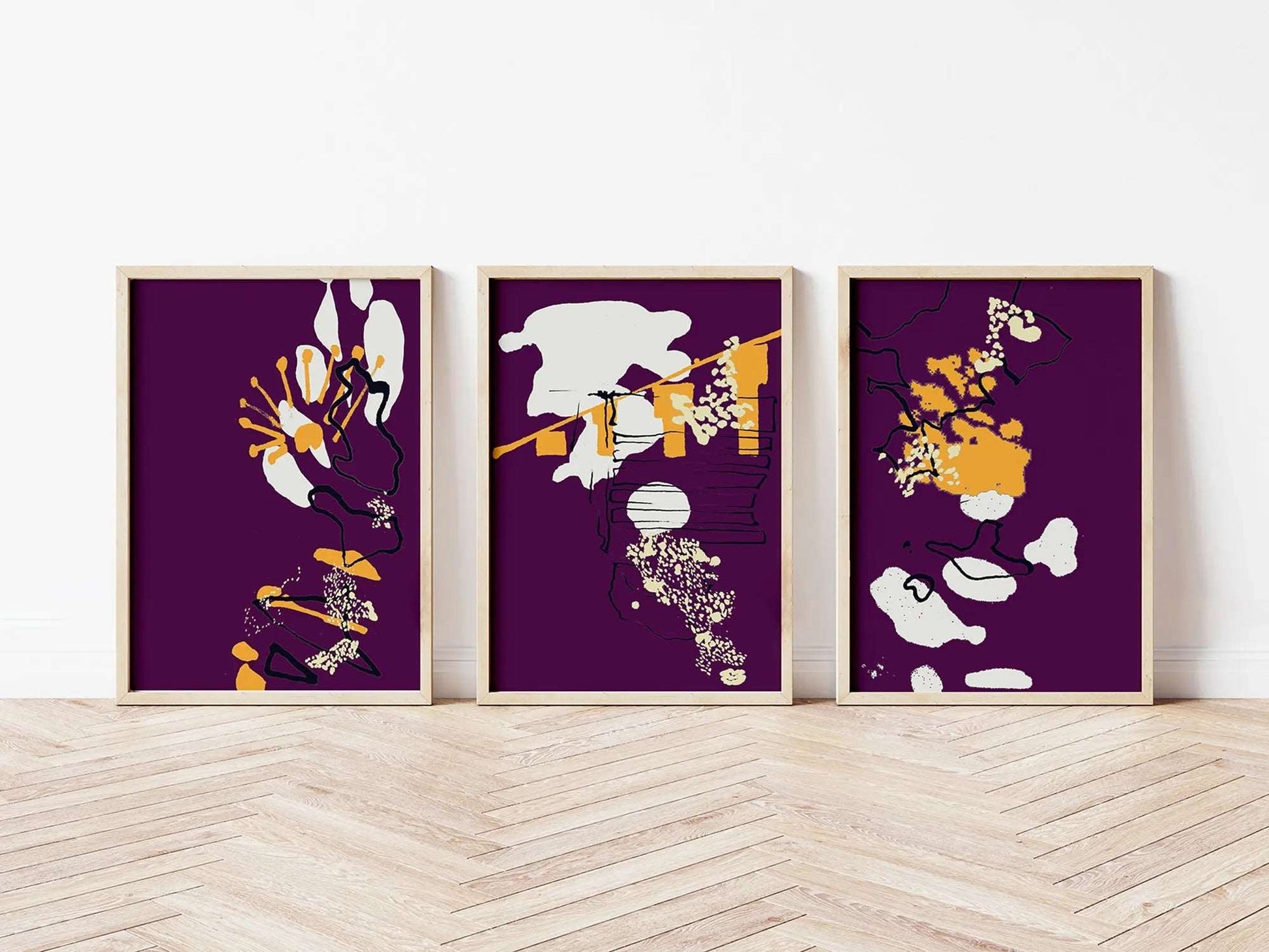 Digital mockup of purple and yellow abstract coastal triptych print set in wooden frames