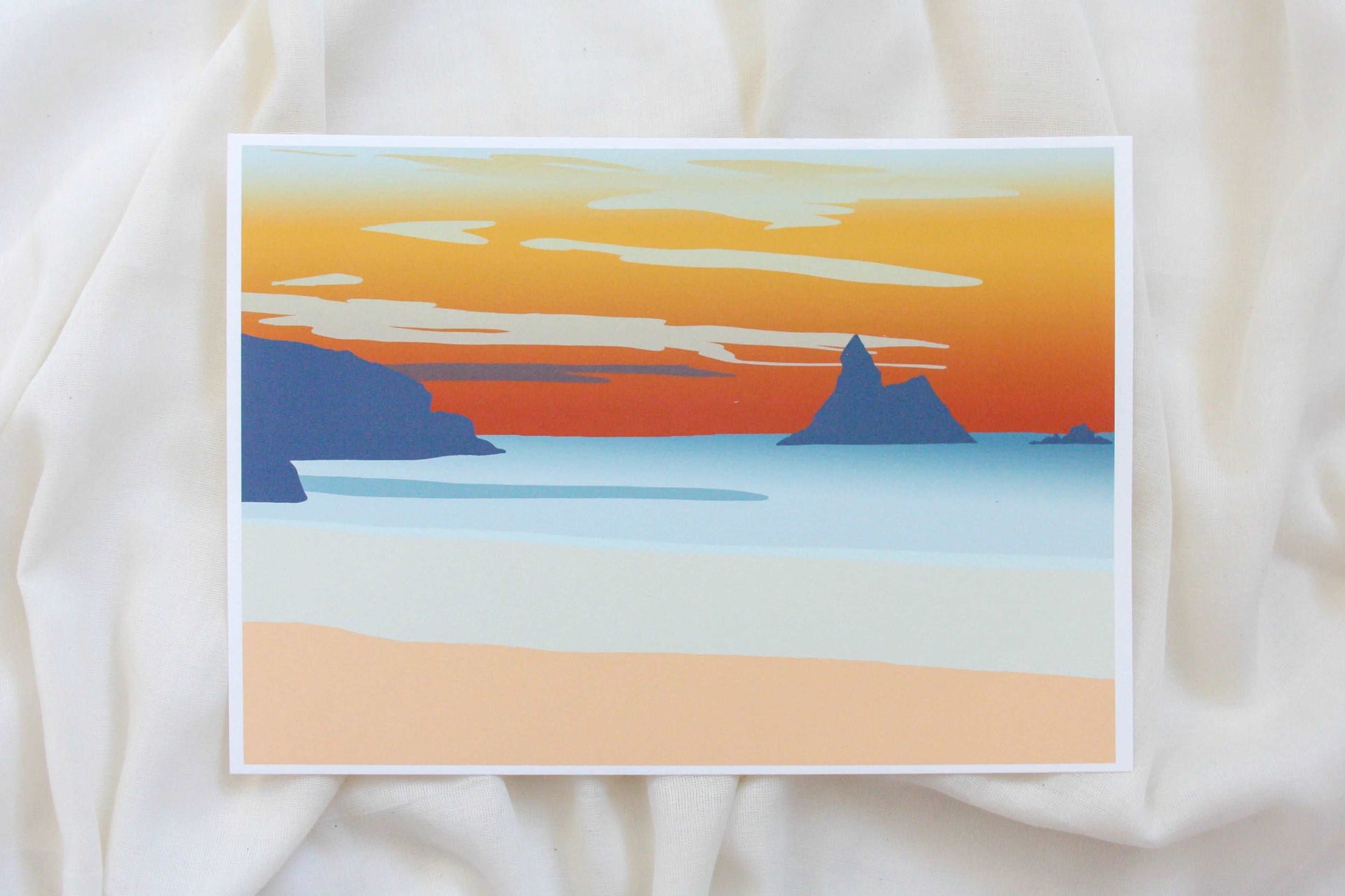 Photo of orange and blue Broad Haven South beach sunset print on cream fabric backdrop