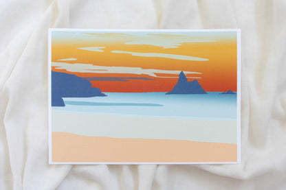 Photo of orange and blue Broad Haven South beach sunset print on cream fabric backdrop