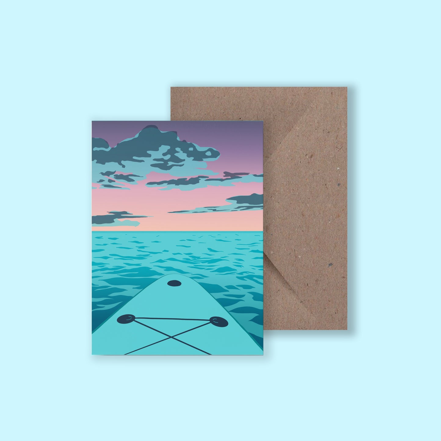 A mockup of a greeting card with an illustration of a purple sunset from the viewpoint of a paddle boarder on their board, with a brown envelope behind, on a light blue background.