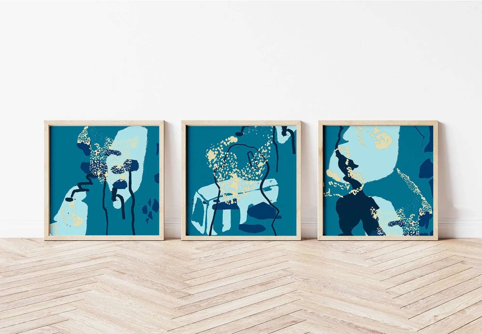 Digital mockup of turquoise, teal and blue abstract coastal triptych print set in wooden frames