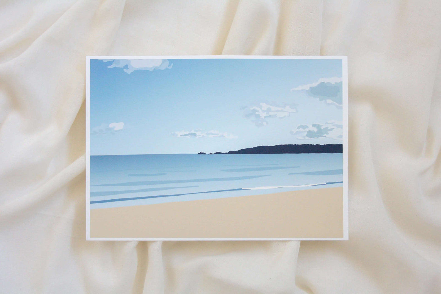 Photo of blue Swansea bay print on cream fabric backdrop